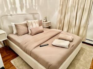 a bed with two pillows and a remote control on it at Me-Skye waterfront retreat in Baldwin