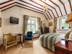 a bedroom with a bed and a desk and a tv at Moyvannan Castle on 7 Acres in Roscommon