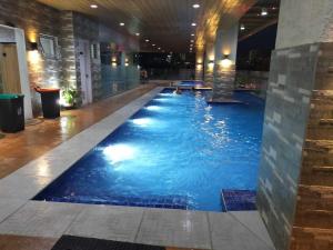 a large swimming pool in a hotel lobby at Sunvida Tower 2819-2818 in Cebu City