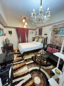 a living room with a bed and a couch at Sunvida Tower 2819-2818 in Cebu City