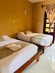 Un pat sau paturi într-o cameră la Hotel Rosa de los vientos