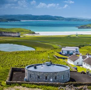 an aerial view of a building and the ocean at Downings Coastguard Cottages - Type B-E in Downings