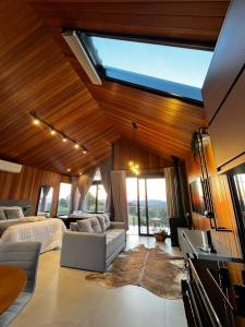 a large living room with a bed and a couch at Le Mont Chalés in Bento Gonçalves