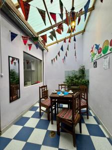 a dining room with a table and chairs and flags at Tika house in Cusco