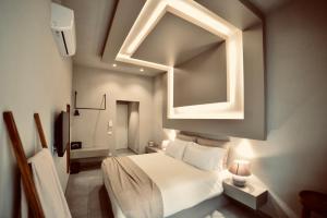 a bedroom with a white bed and a mirror at Palermo Inn Boutique Arte in Palermo