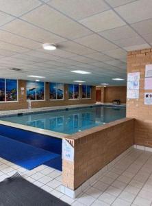 a large swimming pool in a large building at Hilltop Hideaway 2 Bed Caravan with Panoramic Town Scenery in Aberystwyth Holiday Village F8 in Aberystwyth