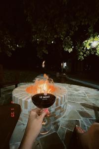 a person holding a bowl with a fire in it at Le Mont Chalés in Bento Gonçalves +31 photos