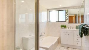a bathroom with a shower and a toilet and a sink at 21st Century 7 in Port Macquarie