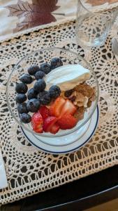 a bowl of fruit and yogurt on a table at Rose & Thistle B&B Lunenburg in Lunenburg