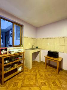 a kitchen with a sink and a window and a table at Tika house in Cusco