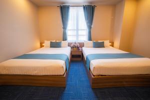 Postel nebo postele na pokoji v ubytování Rum Vang Hotel Da Lat