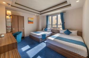 Postel nebo postele na pokoji v ubytování Rum Vang Hotel Da Lat