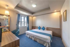 Postel nebo postele na pokoji v ubytování Rum Vang Hotel Da Lat