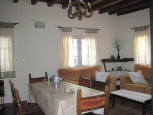 a living room with a table and a couch at Casa de piedra en el Valle de Lozoya in Canencia