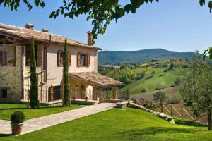 a house with a view of the mountains at La Corte del Gusto LuxuryApartments in Arcevia