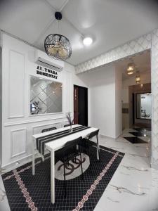 a dining room with a white table and chairs at Aisywara Homestay Kuala Terengganu in Kuala Terengganu