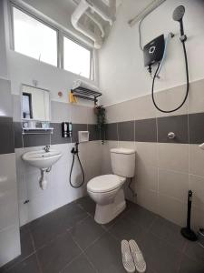 a bathroom with a toilet and a sink at Aisywara Homestay Kuala Terengganu in Kuala Terengganu