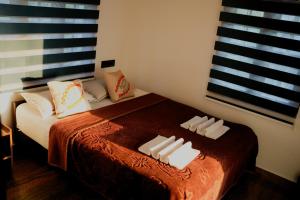a bedroom with a bed with two towels on it at Summer Beach House in Alleppey
