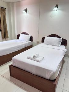 Ένα ή περισσότερα κρεβάτια σε δωμάτιο στο Phurafah Place Hotel โรงแรมภูระฟ้า เพลส