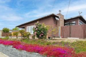 a house with flowers in front of it at 1580 - SFO Spacious & Beautiful 3BR house in Milbrae in Millbrae