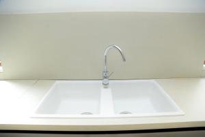 a sink in a kitchen with a white counter at Luxury Lakeside Villa Gated in Entebbe