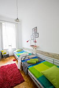 a bed room with two beds and a desk at Friends Hostel & Apartments in Budapest