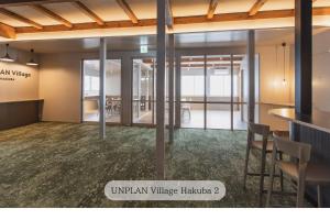 an image of an empty room with tables and chairs at UNPLAN Village Hakuba in Otari