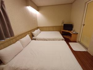 Postel nebo postele na pokoji v ubytování Long Cherng Hotel