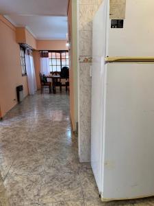 a white refrigerator in a hallway with a dining room at Kairos in Buenos Aires +9 photos