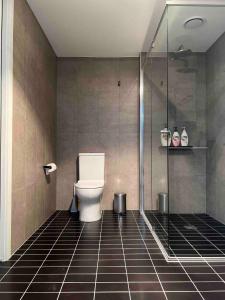 a bathroom with a toilet and a glass shower at Brand new 1 bedroom apartment in Canberra Centre in Canberra +12 photos