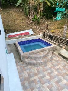 a swimming pool with blue tile around it at CASALOMA in La Vega