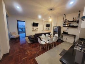 a living room with a table and a couch at Pórtico tower in Cochabamba +19 photos