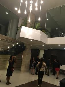 a group of people standing in a lobby at Pórtico tower in Cochabamba