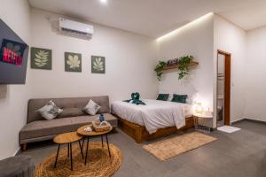 a living room with a bed and a couch at Standart Room in Sanur +64 photos