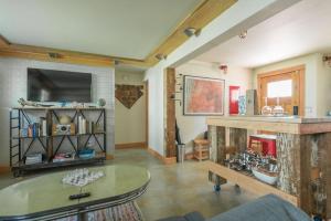 a living room with a table and a tv at Cozy Spa Sanctuary - Steps to Restaurants and Shopping in Portland