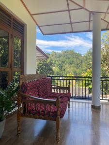 a couch on a porch with a view of a balcony at Oasis Suite in Kandy