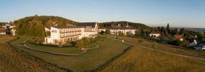 an aerial view of a large building on a grass field at Hotel St Elisabeth in Allensbach