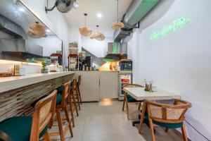 a restaurant with a table and chairs and a counter at Standart Room in Sanur