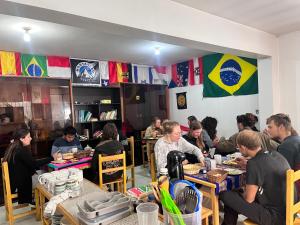 a group of people sitting at tables in a restaurant at Montañero Hostel in Huaraz +32 photos