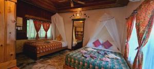 a bedroom with two beds in a room at Longtail Beach Resort in Thong Nai Pan Yai