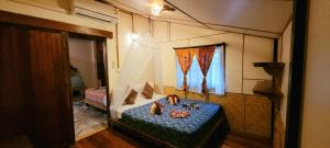 a room with a bed with a table and a window at Longtail Beach Resort in Thong Nai Pan Yai