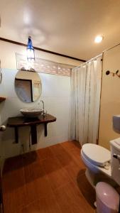 a bathroom with a toilet and a tv on a table at Longtail Beach Resort in Thong Nai Pan Yai +37 photos