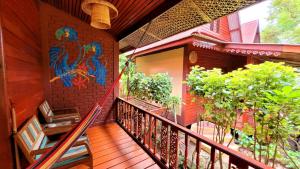 a balcony with a mural on the side of a building at Longtail Beach Resort in Thong Nai Pan Yai