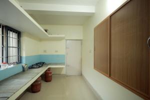 a room with a hallway with a door and a window at Toms Villa along National highway Thrissur at Nadathara in Trichūr +4 photos