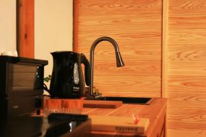 a kitchen counter with a sink and a microwave at 千年乃宿 in Kubo +71 photos