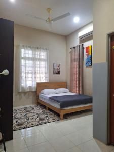 a bedroom with a bed and a window at DN Homestay Kuala Terengganu - Feel At Home in Kuala Terengganu