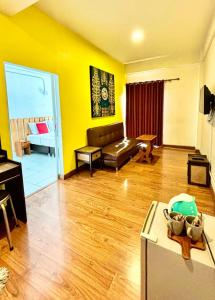 a living room with a couch and a table at Yak Guesthouse in Chiang Mai