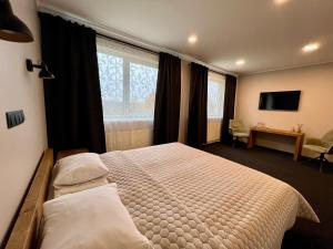 Postel nebo postele na pokoji v ubytování Hotel Sanvilla