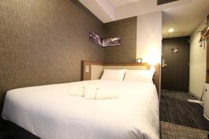 Postel nebo postele na pokoji v ubytování KOKO HOTEL Ginza-1chome