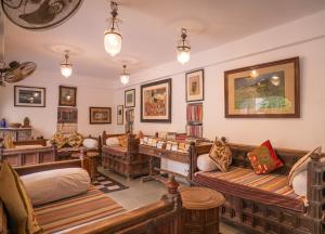 a room with several couches and a desk at Kankarwa Haveli in Udaipur +24 photos